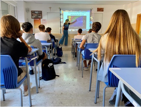 Students attending an astronomy presentation in a classroom.